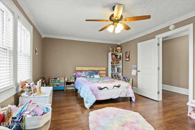 bedroom with ornamental molding, dark wood-style flooring, ceiling fan, and baseboards