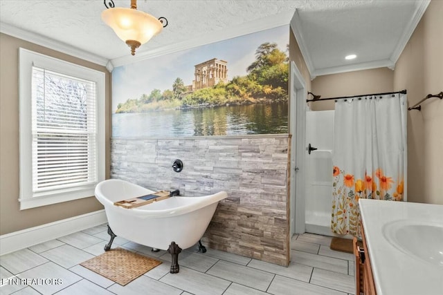 full bathroom featuring a freestanding tub, ornamental molding, a textured ceiling, and vanity