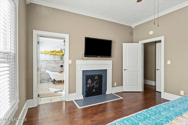 unfurnished bedroom with baseboards, a fireplace, ornamental molding, and dark wood-style flooring