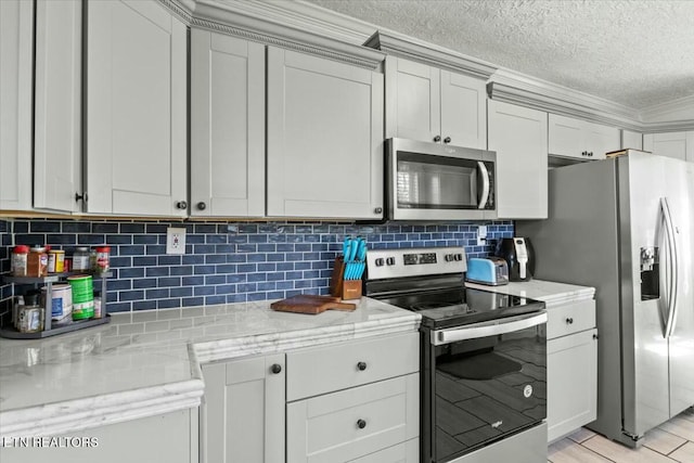 kitchen with light stone counters, decorative backsplash, appliances with stainless steel finishes, ornamental molding, and a textured ceiling