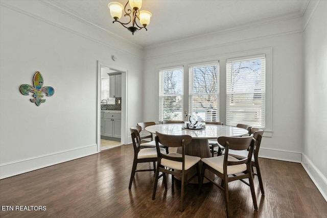 dining room with baseboards, ornamental molding, dark wood-type flooring, and an inviting chandelier