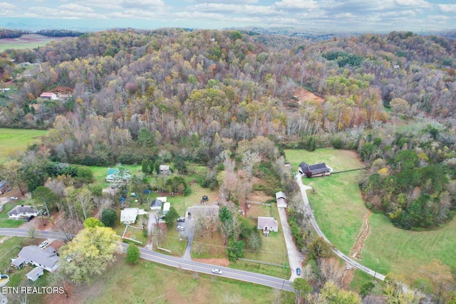 birds eye view of property with a forest view