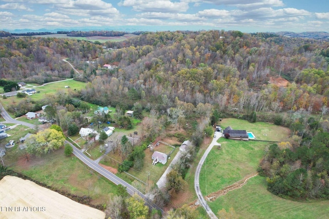 birds eye view of property with a forest view