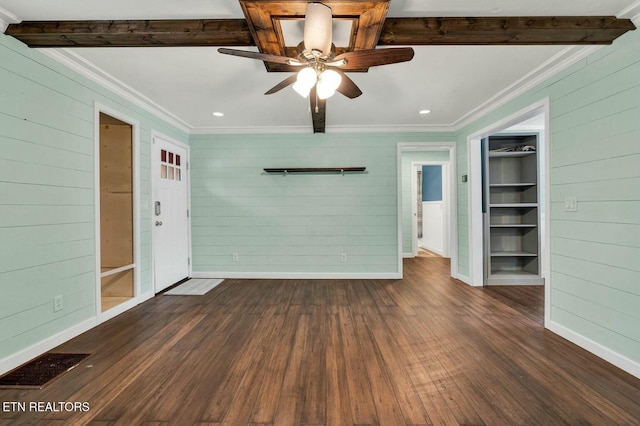 unfurnished living room with beamed ceiling, visible vents, and ornamental molding