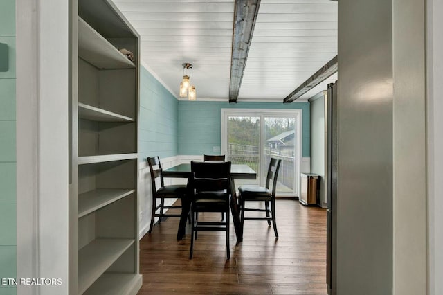 dining room featuring dark wood-style floors and beam ceiling