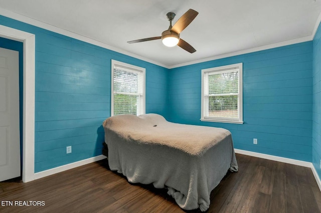 bedroom with ceiling fan, baseboards, and dark wood-style flooring