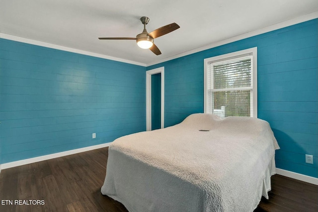 bedroom with baseboards, dark wood-type flooring, and a ceiling fan