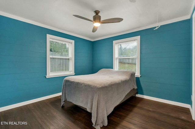 bedroom with baseboards, multiple windows, and dark wood-style flooring