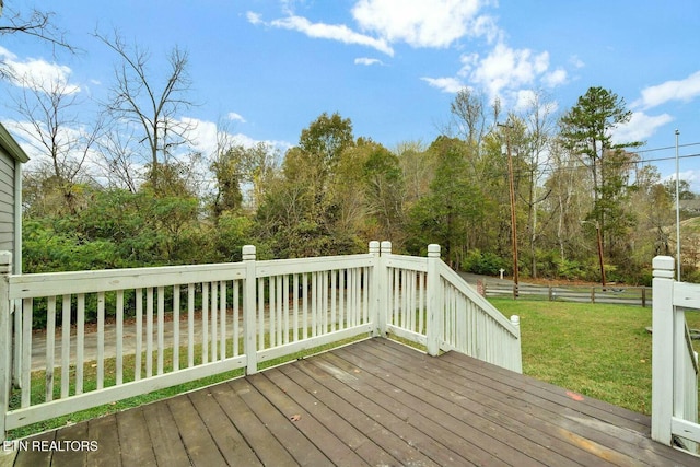 wooden deck with a lawn