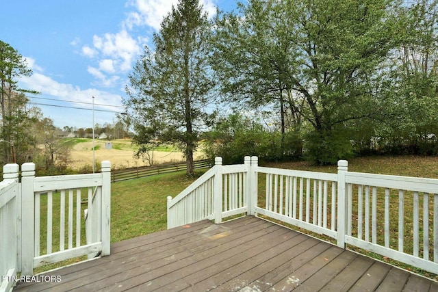 deck with a lawn and fence