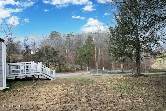 view of yard with a deck and fence