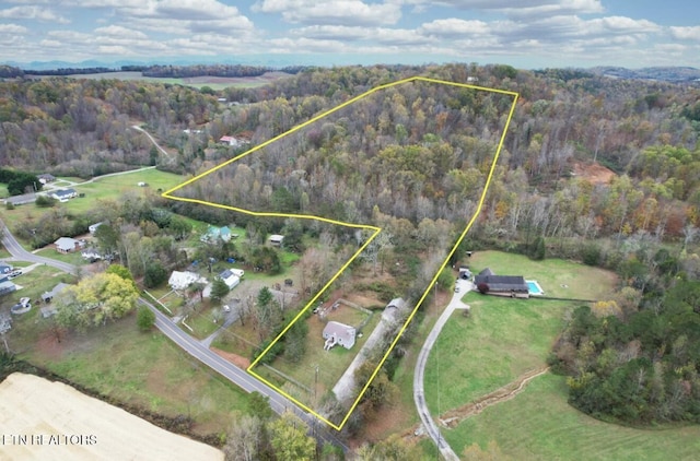 birds eye view of property with a forest view