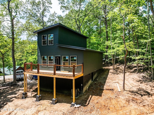 rear view of property with central AC unit and a wooden deck