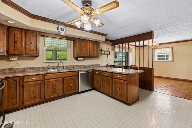 kitchen featuring a peninsula, a sink, ornamental molding, and dishwasher