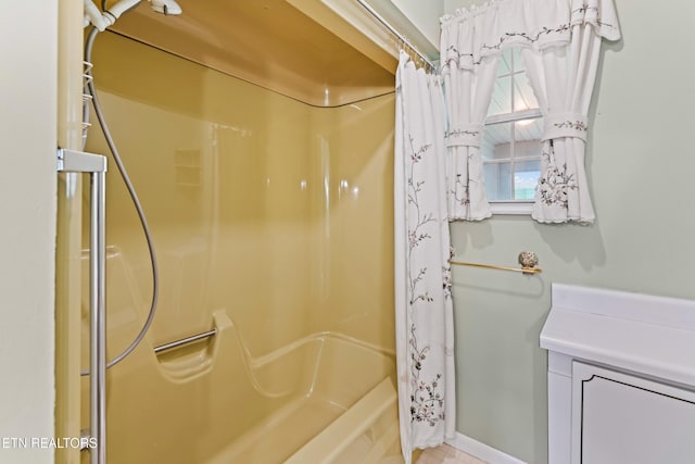 full bathroom featuring shower / bathtub combination with curtain and baseboards