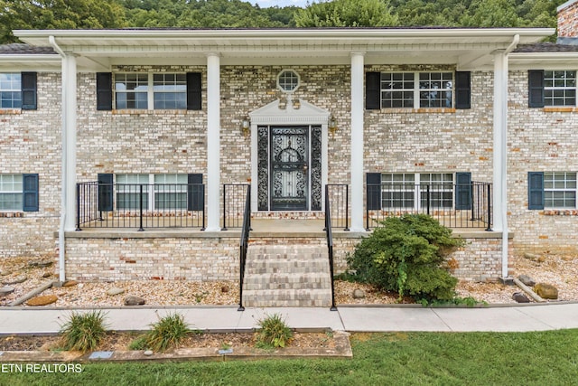 view of front of house featuring brick siding