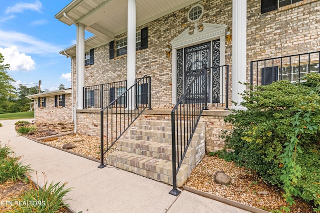 property entrance featuring brick siding