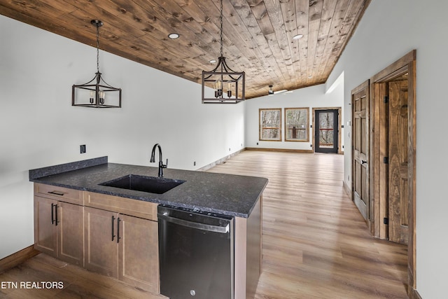 kitchen with open floor plan, decorative light fixtures, dishwasher, and a sink