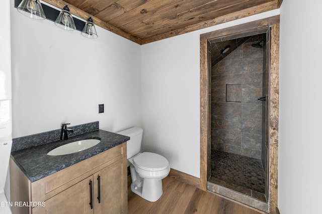 full bathroom with a stall shower, vanity, toilet, and wood finished floors