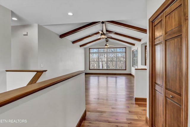 hallway with vaulted ceiling with beams, light wood-style flooring, recessed lighting, an upstairs landing, and baseboards