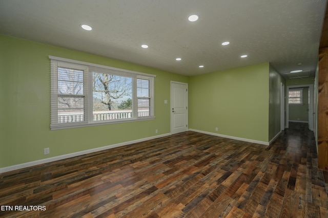 spare room with a healthy amount of sunlight, recessed lighting, and baseboards