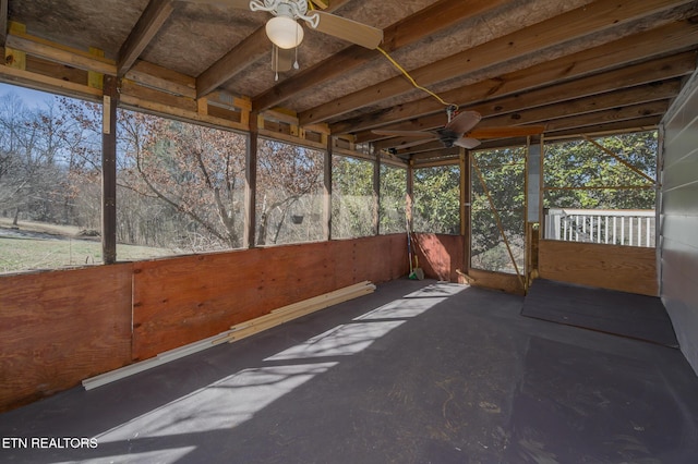 unfurnished sunroom with a ceiling fan