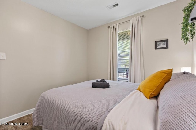 bedroom with carpet, visible vents, and baseboards