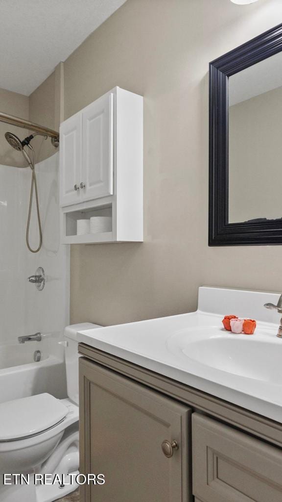 bathroom with toilet, bathtub / shower combination, and vanity