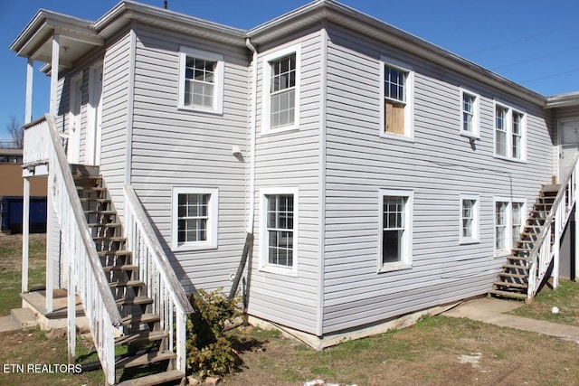 rear view of house featuring stairway