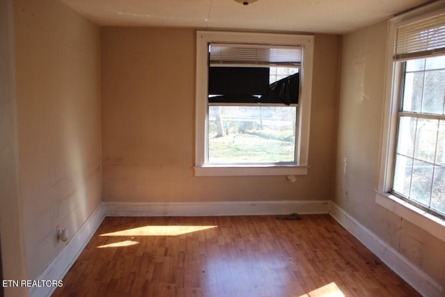 empty room featuring light wood-style floors and baseboards