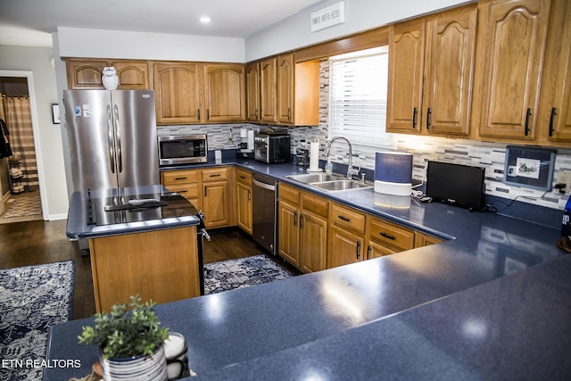 10 Dockside Dr, Crossville, TN 38558 - kitchen with dark countertops, brown cabinets, appliances with stainless steel finishes, and a sink