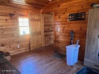 interior space with wood ceiling, wooden walls, and wood finished floors