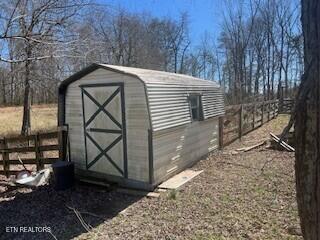 view of shed with fence