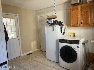 laundry room with washer / clothes dryer, cabinet space, and baseboards