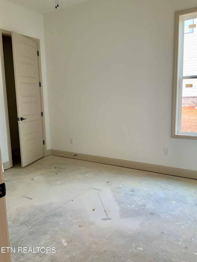 spare room featuring baseboards