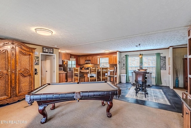 recreation room with carpet, a textured ceiling, crown molding, and pool table