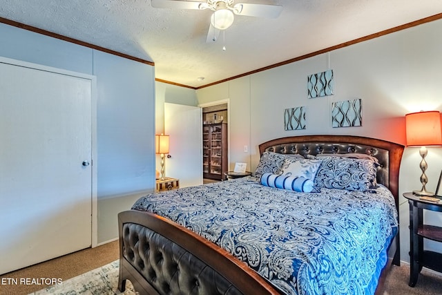 bedroom with a textured ceiling, carpet flooring, a ceiling fan, ornamental molding, and a closet