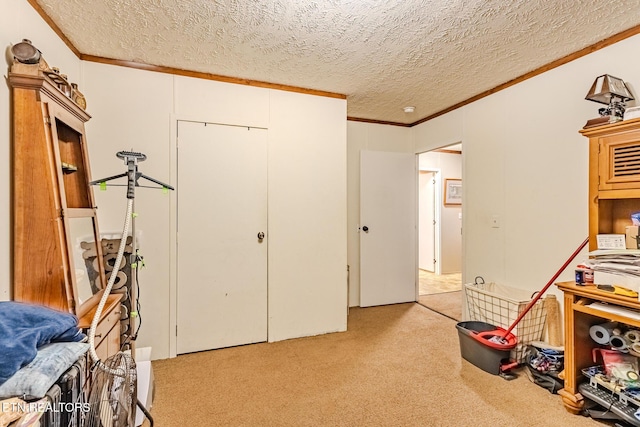 bedroom with a textured ceiling, ornamental molding, and light colored carpet