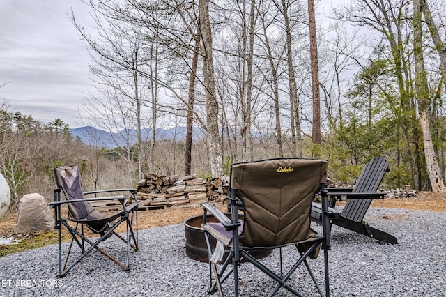 view of patio with a mountain view and a fire pit