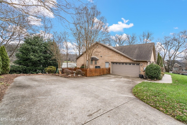 view of side of property featuring brick siding, a shingled roof, fence, concrete driveway, and a garage