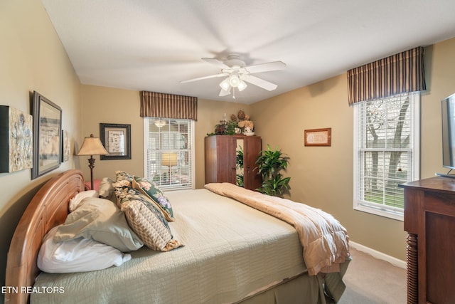 carpeted bedroom featuring a ceiling fan and baseboards