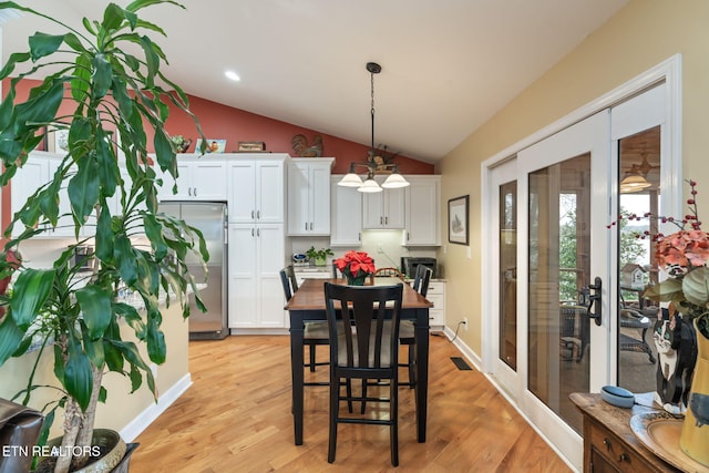 dining area featuring light wood finished floors, recessed lighting, baseboards, and lofted ceiling