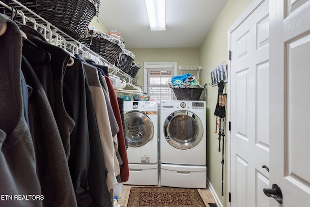 laundry area featuring light tile patterned floors, laundry area, and washer and dryer