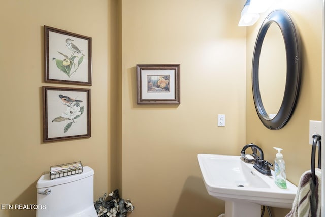 half bath with a sink and toilet