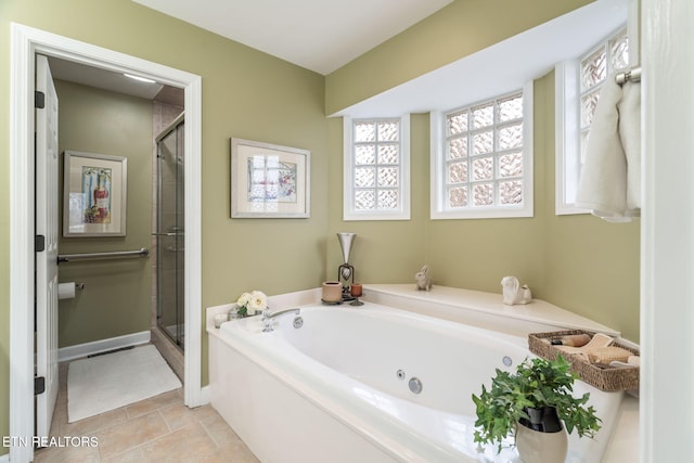 full bath featuring tile patterned floors, baseboards, a stall shower, and a whirlpool tub