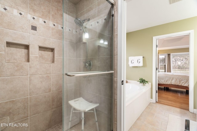 ensuite bathroom featuring a bath, a shower stall, and ensuite bath