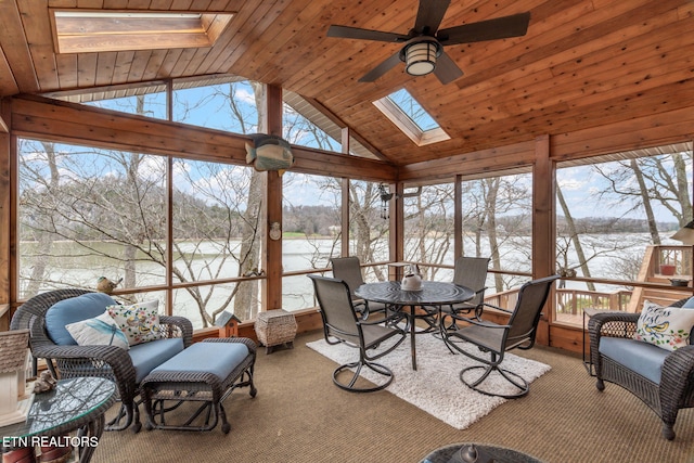 sunroom / solarium featuring lofted ceiling with skylight, ceiling fan, and wooden ceiling