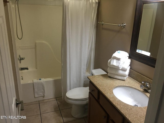 bathroom featuring toilet, vanity, shower / bath combo with shower curtain, and tile patterned floors