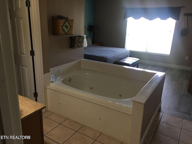 bathroom featuring tile patterned flooring and a bath