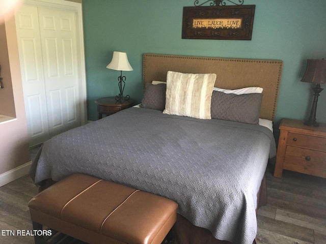 bedroom featuring dark wood-style floors and baseboards